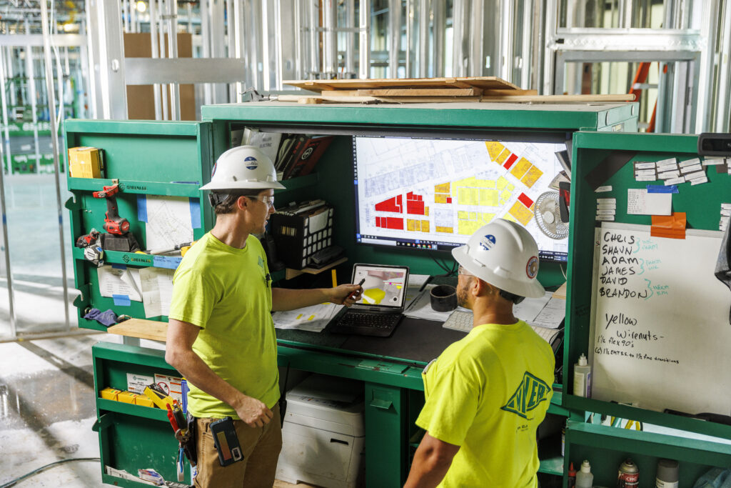 Miller electric workers discussing a project