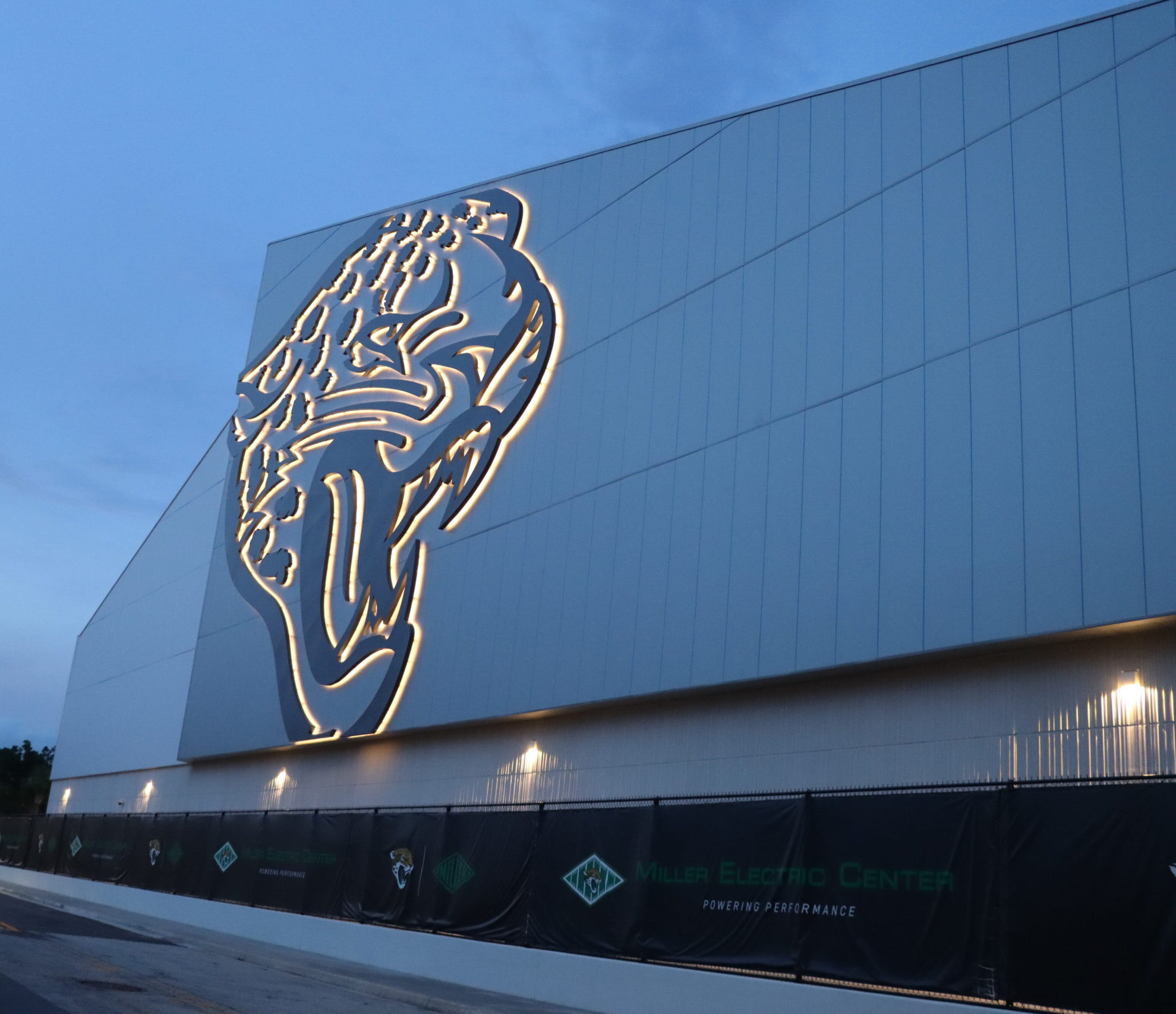 Side of the Jaguars practice building that has a large Jaguars logo on it.