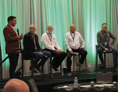 Group discussion panel sits on stools