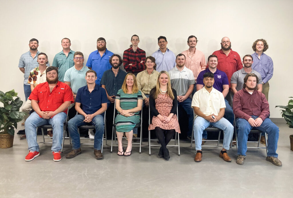 Apprentice graduates posing for a group picture