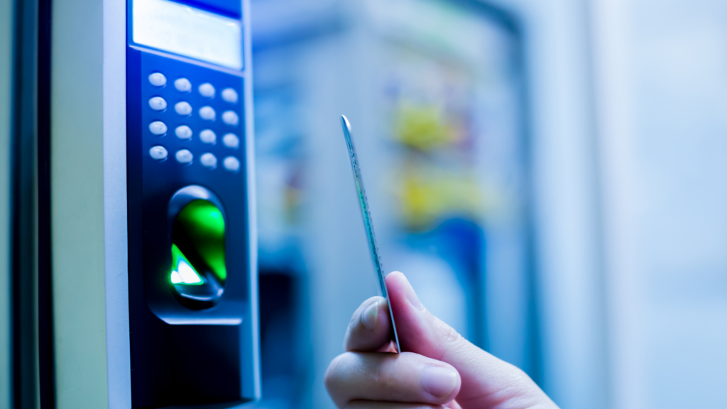 Person holding a keycard by a Access Control Terminal