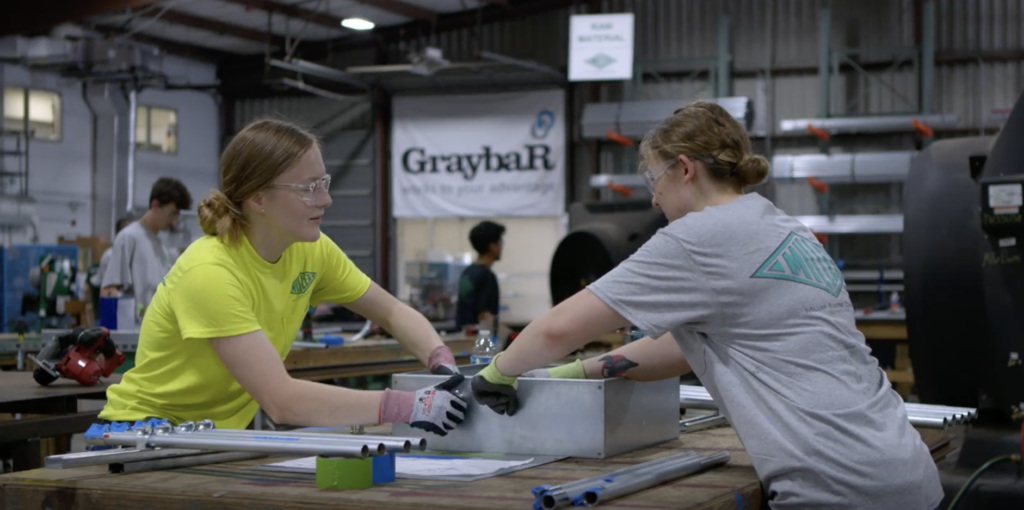 Women apprentices working on a project on a table