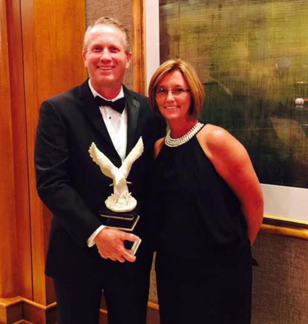 Brian holds an award