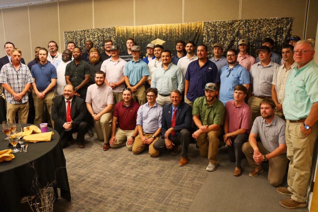 Apprentice graduates posing for picture