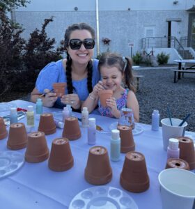 Woman and daughter painting a craft