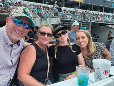 Brian and family pose for selfie in stadium stands