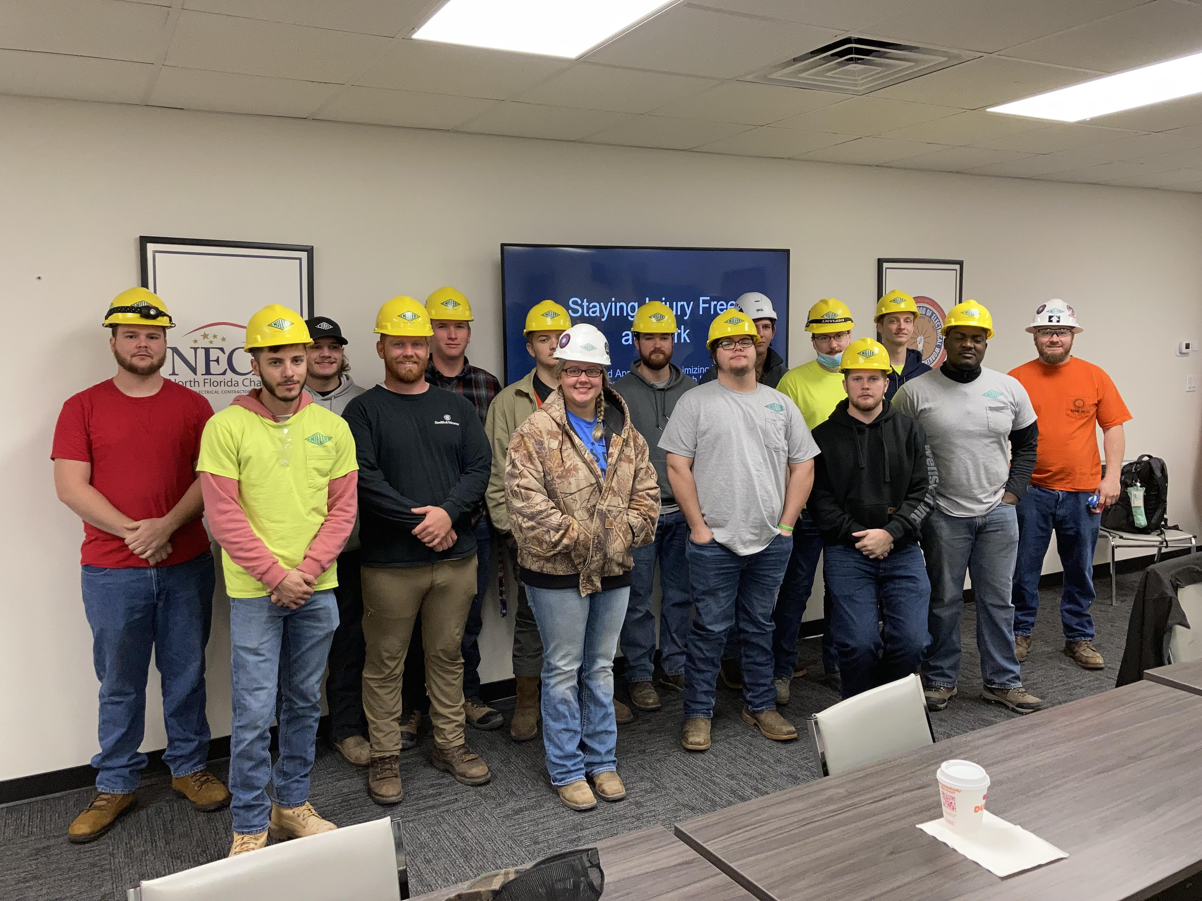 Group of entry level electricians wearing hard hats