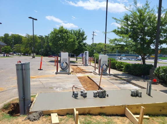 Electrical vehicle charging stations being added to parking lot.